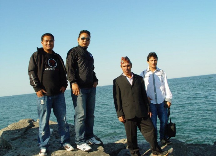 Visits to local parks and natural places are a favorite summer pastime of these friends and neighbors of Shyam San Rai (2nd from left). This photo was taken at Lake Erie and was chosen as the theme image for the, “Refugees Starting Over in Utica, NY,” project because it seems so unlikely that this group of refugee men would find themselves sitting by a lake in New York State. This is also an example of one of the hundreds of images that the project collected from refugees’ personal Facebook pages and exhibited (with permission) in a gallery exhibit at the SUNY Institute of Technology in Dec. 2012. Photographer: San Acharya.