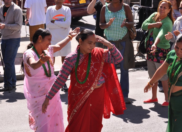 There are few things that make Dorna Baniya and Guyatri Rijal happier than dancing. It is rare that they get a chance to share their culture with an audience outside of the local refugee center. This photo was taken at the Utica Music and Arts festival, Sept. 15, 2012. Photographer: Lynne Browne.