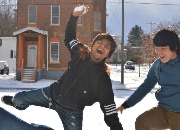 Abi Darjhee takes a break from his job at a factory to have some fun in the snow with friends. Utica, NY has remarkably cold winters and is very different from the Eastern Nepali climate. Community members are still adjusting to the burden of wearing winter clothing and are sometimes seen walking through the snow in their sandals with no socks. Dec. 2013. Photographer: Krishna Akhikari.