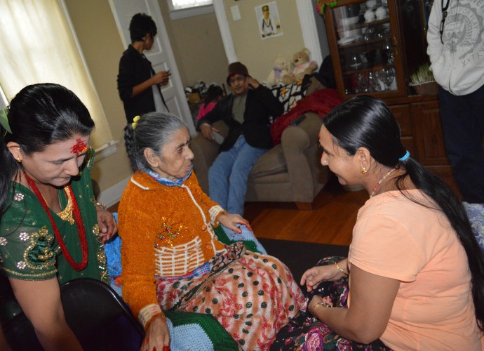 During important days for Hindus, it is still important to visit elders and request that they give a “tikka” (red paste with rice placed on forehead) and a blessing. Nov. 2013. Photographer: Krishna Adhikari.