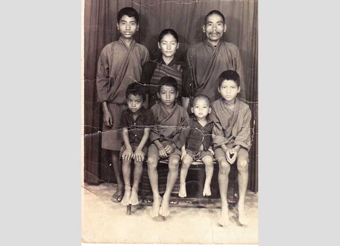 The Bhutanese government conducted a census in 1988 and required that every family submit a group photograph. This photo of the Ranamagar family was taken just a few weeks before they were forced to leave Bhutan as refugees in 1992. From there, the family moved to Goldhap and then Beldangi 3 refugee camps in Jhapa, Nepal, where they lived for almost 20 years before being resettled to Utica, NY. Amber Ranamagar (from the previous two photos) is again featured here standing up on the far left. Photographer: Unavailable. Permission to publish from Harka Ranamagar.