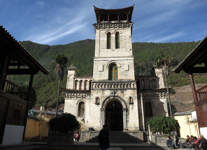 <b><p>Cizhong Church built with Western and Chinese architectural styles.</b></p>
The village of Cizhong is situated along the upper Mekong River in Diqing Tibetan Prefecture of Northwest Yunnan Province. A unique feature of Cizhong is that the community consists of many Tibetan Catholics, a religion that French and then Swiss missionaries introduced in the late 19th and early 20th centuries (Deshayes 2008; Lim 2009). This is highly unusual in and of itself since Tibetans are known worldwide as devout Buddhists. Additionally, the Catholic missionaries introduced grape cultivation and winemaking to this village; both practices that have been revived and carried on by villagers today in response to increasing tourism interest in Cizhong and its Catholic history.