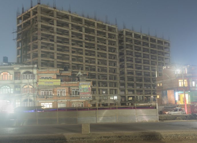 The old and the new co-exist: a high-rise under construction beside an older building near Gwarko, Patan. (Kumar, December 16, 2016).