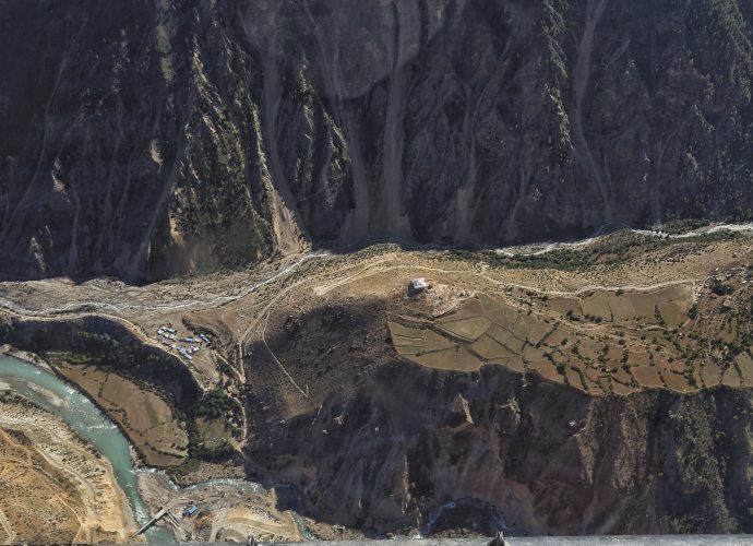 Tumkot, September 2017.
Tumkot (mid-left) is the most prominent road head market after Hilsa. It used to be a tourist campsite managed by Tumkot village (located above on the flat hill). It sprung up four years ago when the road reached the end of the delta formed by the confluence of the Karnali River and the stream from Yari. In July 2017, construction of the Tumkot bridge was completed and, as a result, the largest road head market at Tumkot has already reduced in size. Although the construction of the road briefly transformed it into a vibrant market, its future is uncertain. Depending on the speed of construction, the next road head market is expected to find a brief life in Yalbang, before shifting to Kermi for a longer duration.