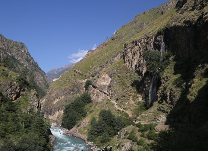 Kermi to Dharapori road section, October 2017.
Arguably one of the most dramatic sections of the Hilsa – Simikot route, the Chachara cliff overlooks the Karnali river below to form the base of Chaduk, a village located directly overhead. The streams from the village drop over 200 meters below forming a picturesque waterfall. The cliff is approximately a kilometer in length and forms the biggest hurdle in completing the road and reaching the district headquarters of Simikot. Reportedly, the explosives necessary to sculpt the cliff are not available in Nepal. The Nepal Army (NA) has been called in to undertake the task, but it might be years before this work is completed. Because of the cliff, people in Kermi believe that a major road head market might come up near Kermi. Currently, there are only three small tea shops each in the north and south of Kermi, but none in the village.
