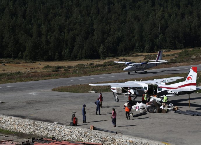 Simikot airport, October 2017.
While waiting for flights at Simikot airport in October, someone in the crowd sarcastically shouted, “Ayo, ayoo…Giddha Air ayoo” (Eagle Air is coming), which happens to be a popular pun to crack the dullness of endless waiting. Flying on twin-otters and single engines is the easiest way to get to Simikot from Nepalgunj; the other option being 3-5 days walk from the neighboring district. Airlines tend to abandon places like Humla when they need it most, namely, from October to December when Humlis fly down to Kathmandu, and from March to May when they return. This is because the timing coincides with the tourist season in the Everest region when most airlines turn towards ferrying tourists back and forth to Lukla where the trek to the world’s highest mountain begins. Foreigners pay more than twice the local fare, so between June and August when thousands of Indian pilgrims going to Kailash travel through Simikot, airplanes and helicopters compete for space in Simikot airport. There have been several local protests in the Karnali, including the hold up of a few twin-otters for several days in Simikot. Nothing significant has changed when it comes to air transportation for locals in Karnali.
