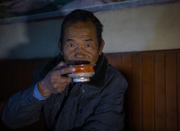 Norbu. (Kory Thibeault, October 2016)
Norbu is a renowned community leader and politician. This photo was taken after a long day working in his apple orchards near the village of Kagbeni. He enjoys a hot butter tea while recounting stories of his life and old customs of the region.