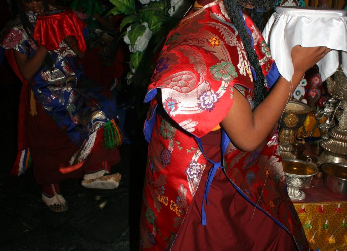 Once the mandala is installed at the centre of the main assembly hall of the monastery, its structure is sealed and forbidden to be opened. The ‘Eight Goddesses,’ played by young monks dressed as goddesses, perform a vivid dance in the Bonpo anticlockwise direction around the mandala, during which they place the mendrup medicinal vessels on the mandala. In the front appears the ‘Goddess’ holding the white bowl representing the Centre.