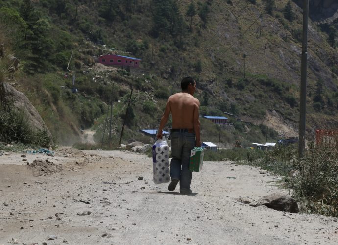 A Chinese worker carrying toilet paper and a box of Lhasa beer to Rasuwagadhi hydropower construction site, Rasuwa. A sizable number of Chinese workers are employed at the hydroprojects in Rasuwa, where they are considered more skilled than Nepalese workers who work alongside them. Unsurprisingly, the residents say the pay gap between the Chinese and Nepalese is quite high, with Nepali workers receiving far less compensation than their Chinese counterpart. 