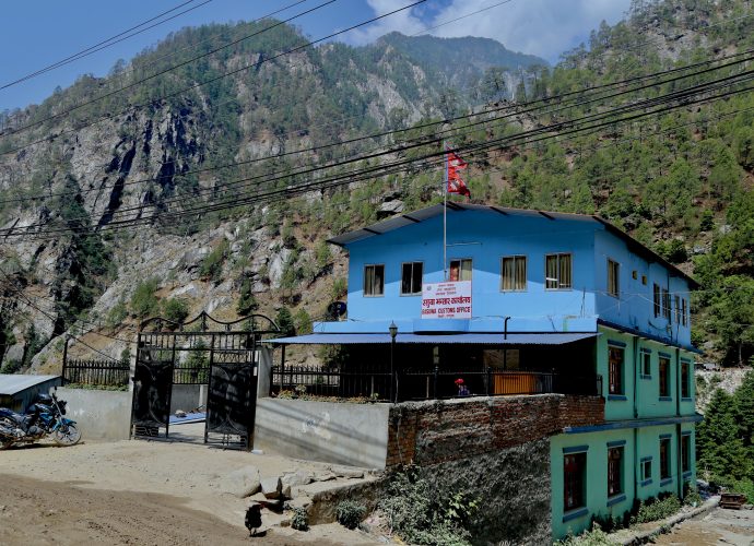 Rasuwa custom office, Timure
After the closure of the Tatopani-Kodari border corridor in the aftermath of the earthquake, Rasuwa became Nepal’s only cross-border corridor with China. Despite poor road infrastructure made worse by recurrent landslides, and import driven trade of Nepal, the custom office at Timure has been relatively ‘successful’ in meeting revenue collection targets set by the Department of Customs over the years. In March 2019, the chief customs officer informed us during a visit to the region that the Timure customs office was successful yet again to meet a set target of Rs. 9 billion [approximately 80 million USD] in revenue within eight months. According to a media report, “the highest revenue, Nepali Rupees 2.32 billion [approximately 20.48 million USD], was recorded in September-October when imports soared due to demand fueled by Dashain and Tihar festivals”. Despite generating large revenues from Rasuwa, the revenue collected goes straight to the national treasury. 