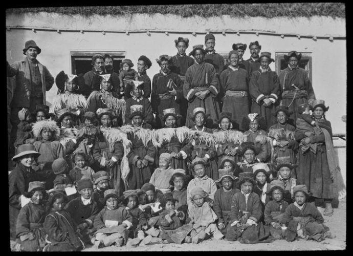 Moravian missionaries, originally from Germany, first visited Leh in 1855 and established a permanent station there in 1885 (see Bezterda 2014). This photograph was taken outside the old church building in Leh, which still exists, although there is now a larger modern church building beside it. The European figure at the top left is Bishop F.E. Peter (d. 1945), a Swiss missionary who served in the Himalaya from 1898 to 1936. The Ladakhi Christian scholar Joseph Gergan (1878-1946) is standing in the middle of the back row, carrying two books in his left hand. Gergan is best known for his contribution to the translation of the Bible into Tibetan. He also wrote a major work on the history of Ladakh.
The European lady at the bottom left may be Julie Trumpler, also from the Central Asian mission, who stayed in Leh at the same time as Elisa Read. Together they helped out in the infant school and the mission dispensary for several months in 1927-1928 while the regular Moravian missionaries were on furlough. Note the traditional Ladakh headdresses (perag, be rag) worn by the three ladies standing below and to the right of Bishop Peter. A perag with a large number of turquoises served as a sign of status among Christian women as well as among Buddhists.